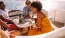 a group of people sitting at a table with drinks on a boat